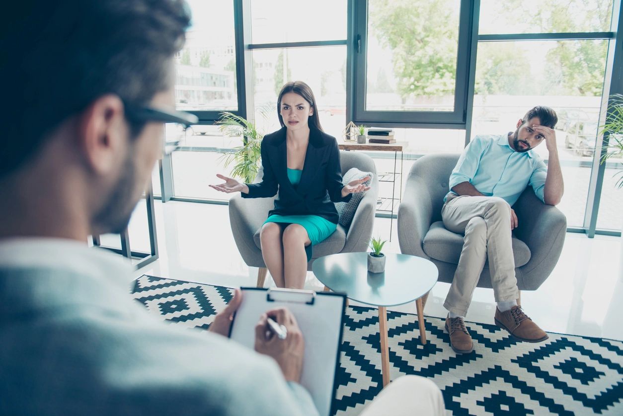 Young Disappointed Brunette Wife Is Asking Advice of the Family Therapist