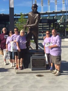 A group of people standing in front of a statue.