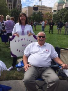 Two people sitting in lawn chairs with a sign that says family life do matter.