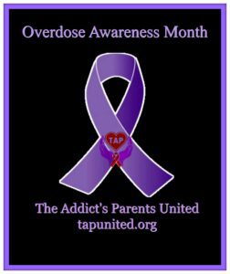 A purple ribbon with the words overdose awareness month.