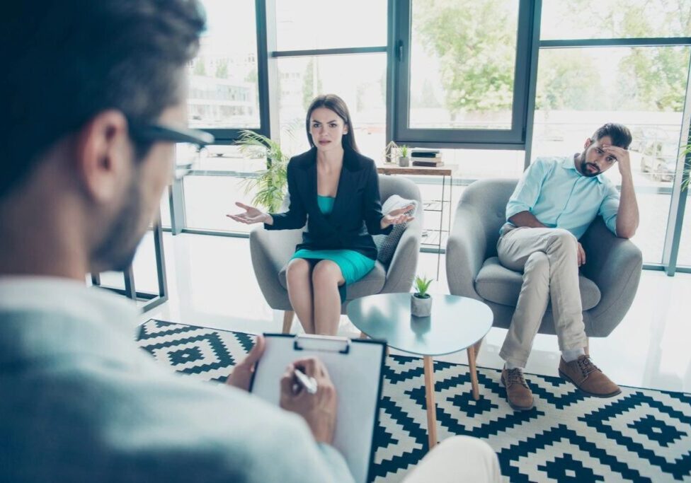 Young Disappointed Brunette Wife Is Asking Advice of the Family Therapist